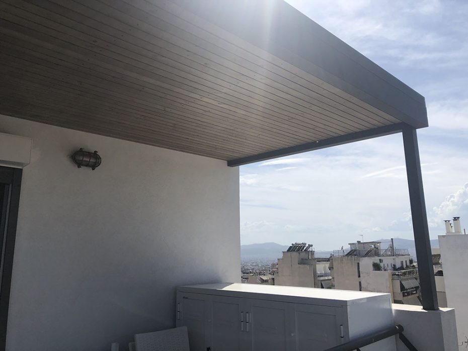 Μεταλλική πέργκολα σε ρετιρέ με πάνελ και επένδυση ξύλου στην οροφή